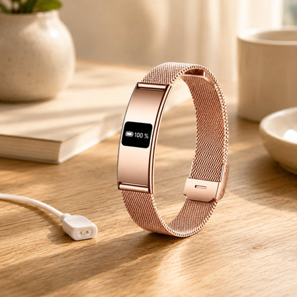 Slunix rose gold sleep band beside its magnetic USB charging cable on a wooden surface, 5 to 7 day battery life